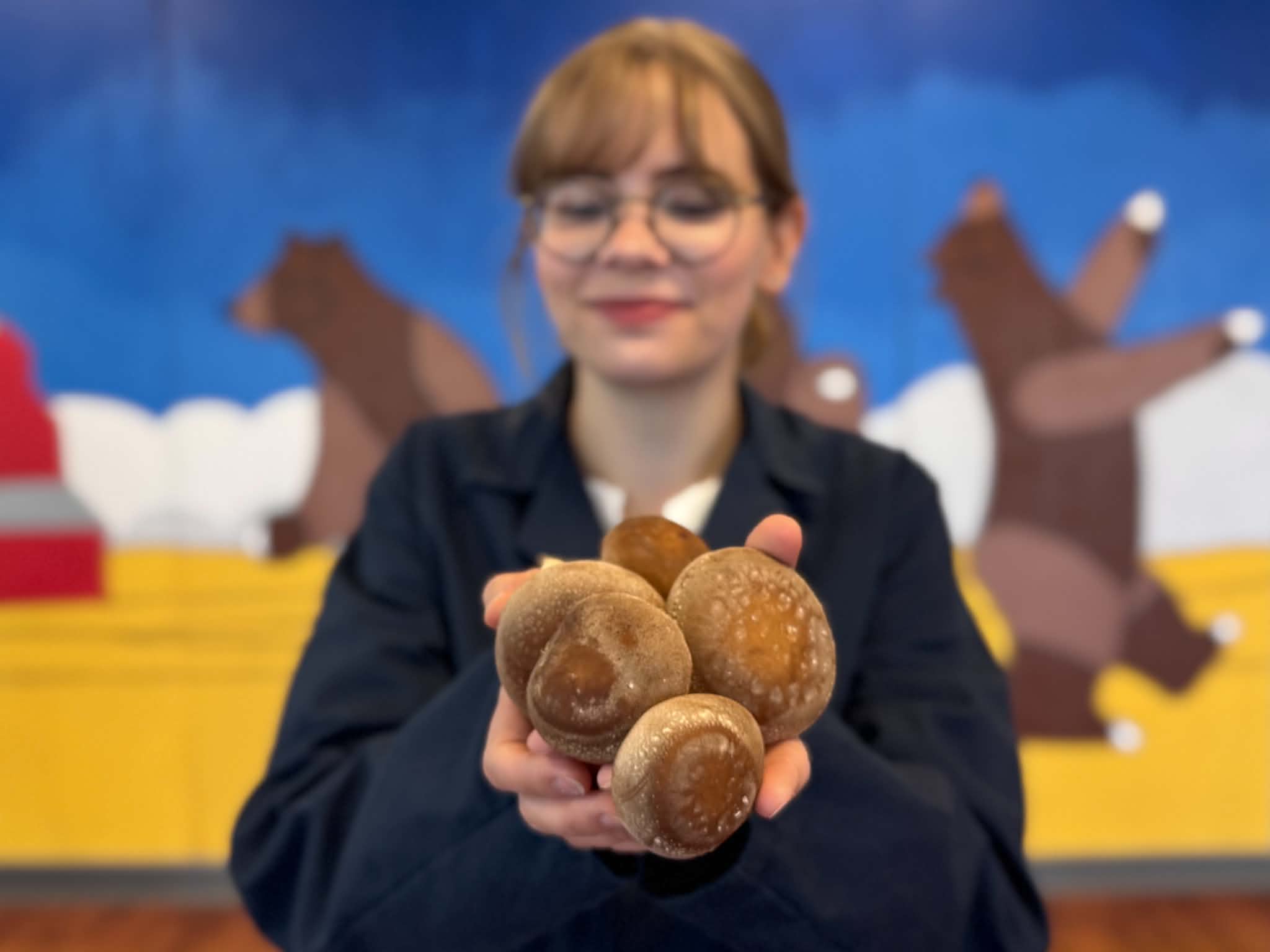 A Ceres grower holding fresh organic shiitake mushrooms